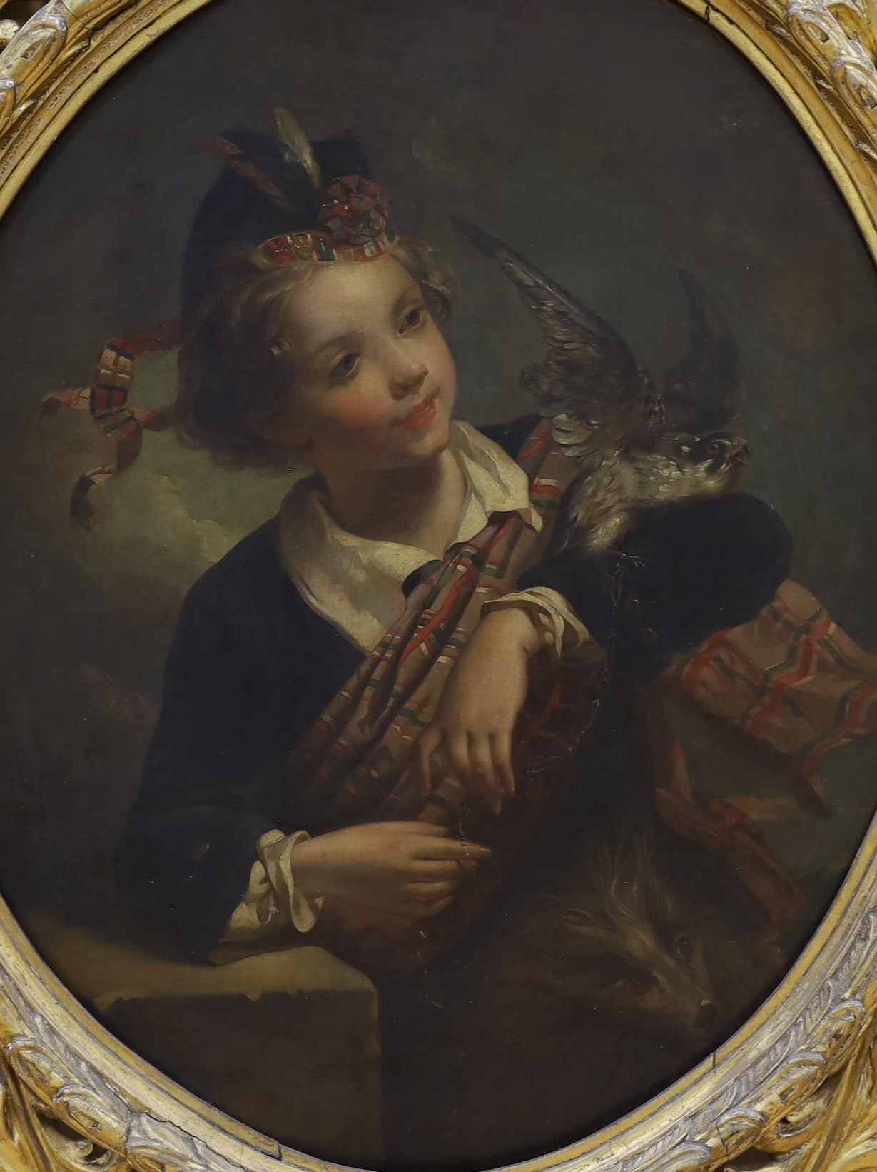 Edwin Landseer (British, 1802-1873) Scottish youth holding a hawk and girl with a dove, pair of oleographs she signed in the plate and dated 1856, ovals, 71 x 58cm. Ornate gilt wood frames